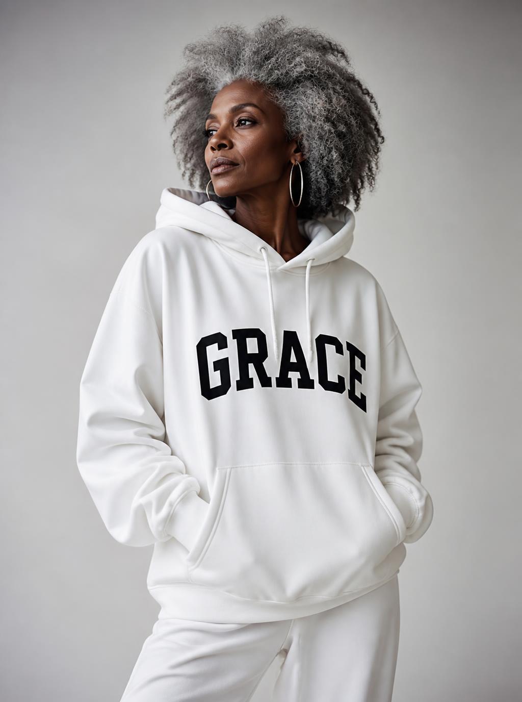 African American woman with gray hair wearing a white Grace hoodie